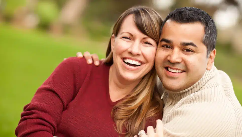 A couple smiling for the camera.