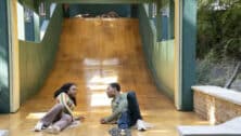 Janine Teagues and Gregory Eddie on the slides during an episode of "Abbott Elementary."