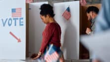 A woman voting at polling station during an election.