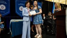 Kaitlyn Cross, HFU's Class of 2024 Valedictorian, on stage at Holy Family University's graduation ceremony.