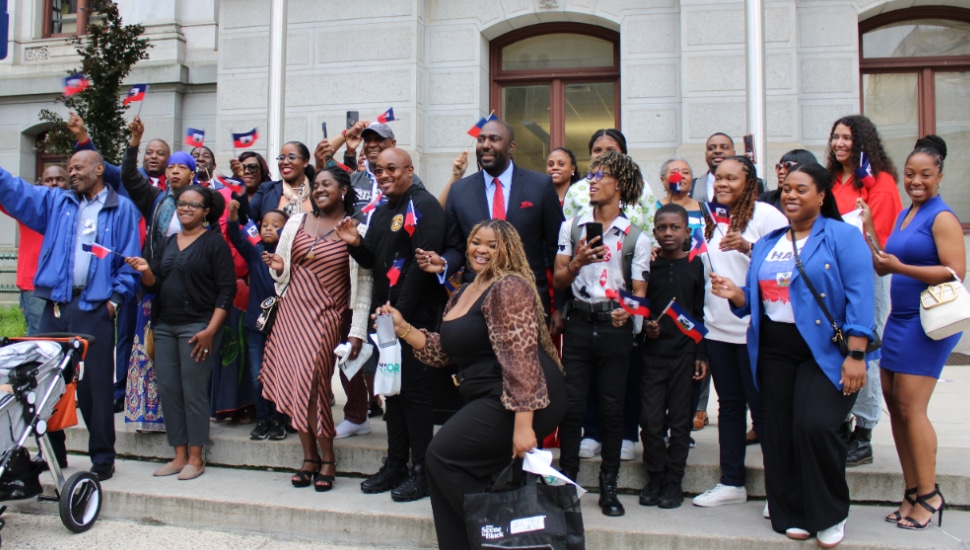 Members of Philadelphia's Haitian community hold the Haitian flag with pride.