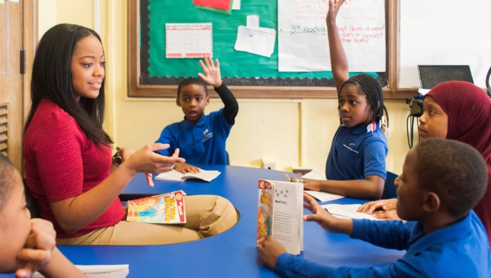 A teacher in a classroom with students.