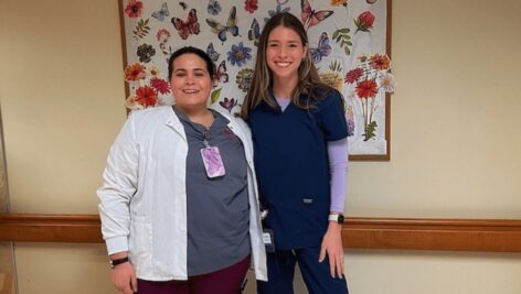 A nursing student senior from GMercyU stands with her nursing mentor from the Dedicated Education Unit program.