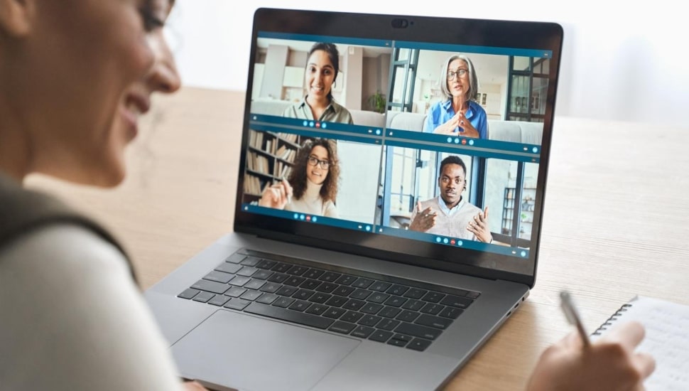 A woman attending a class online.