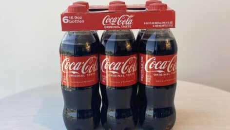 A six-pack of Coca-Cola bottles.