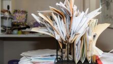 Cluttered desk space with overflowing file folders.