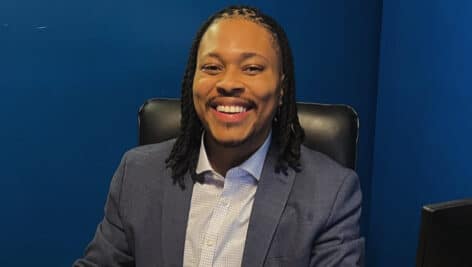 Malcolm Kenyatta smiles in his office.