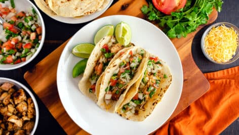 Chicken Tacos Topped with Pico de Gallo and Cheese.