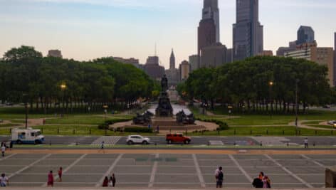 Philadelphia walking and standing outside the Philadelphia Museum of Art.