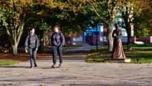 two kids walking on campus