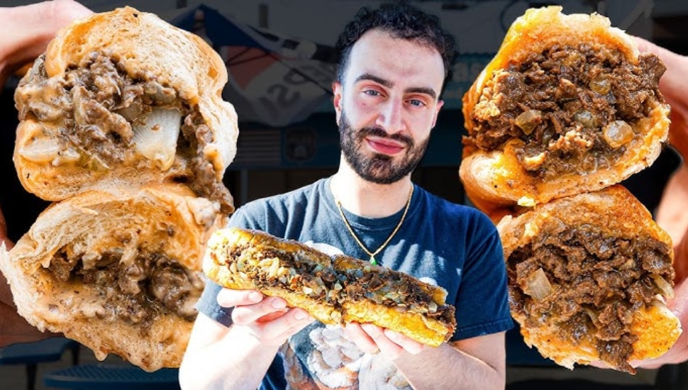 Restaurant Editor Elazar Sontag surrounded by cheesesteaks.