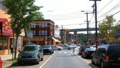 East Falls neighborhood with cars and retail shops.