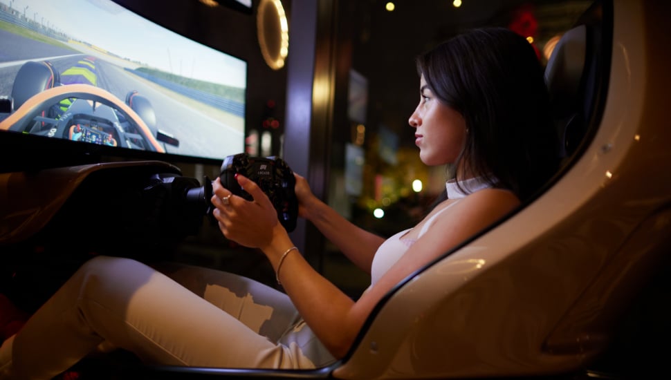 Young women playing F1 Arcade Racing game.