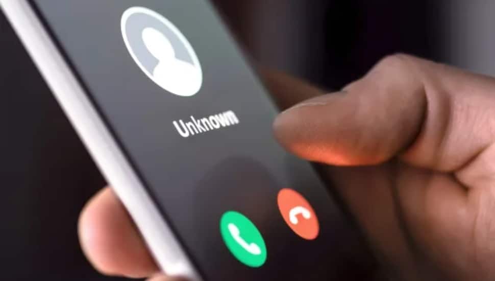 close up of a phone with the words "unknown," indicating a scam.