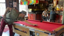 People at the bar and playing pool inside Johnny Brenda's in Fishtown.