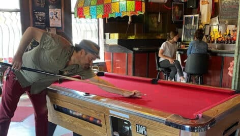 People at the bar and playing pool inside Johnny Brenda's in Fishtown.