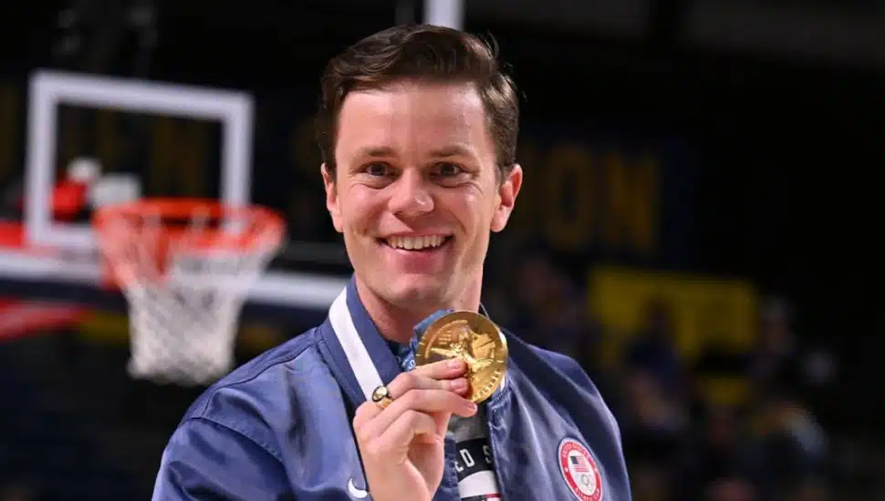 Justin Best showcasing his gold medal.