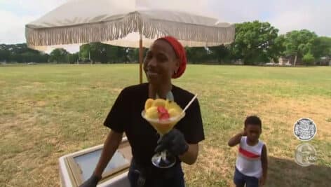 Reason Ali with a float of sorbet in her hand, and her son in the background.