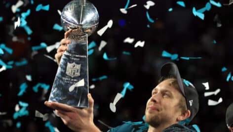 Nick Foles holding up the Super Bowl MVP award trophy.