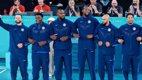 Team USA men's basketball team locking arms.