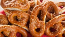 A number of soft pretzels with salt.