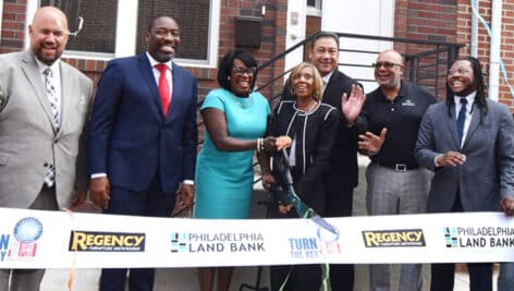 A ribbon-cutting of the 100th home sold in the city's Turn the Keys program.