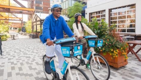 Two people riding their Indego bikes.