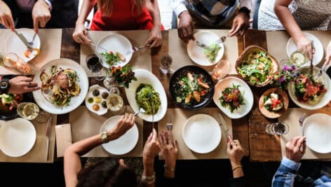 A group enjoying a big collection of food.