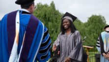 Manor College's 73rd Commencement Ceremony - May 16, 2024. A student walks across stage for diploma.