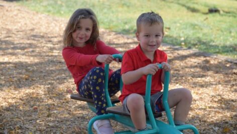 A boy and girl enjoy new playground equipment at Whitemarsh's Magical Miles Park in Lafayette Hill.