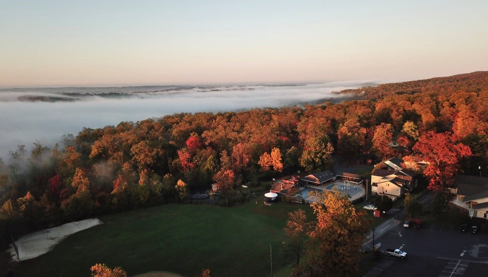 An aerial view of Refreshing Mountain in Lancaster County. The landscape is filled with colorful fall trees and the woodland expanse.