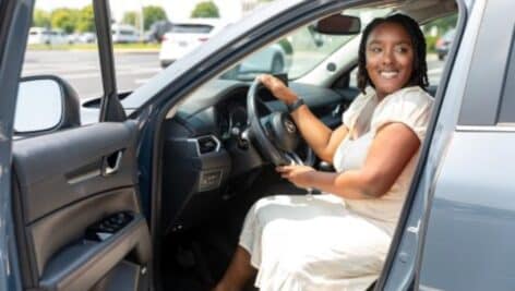 A woman in her car.