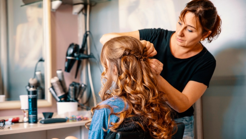 A woman getting hair done at a hair salon.