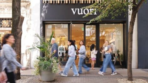 People walking in front of Center City business.