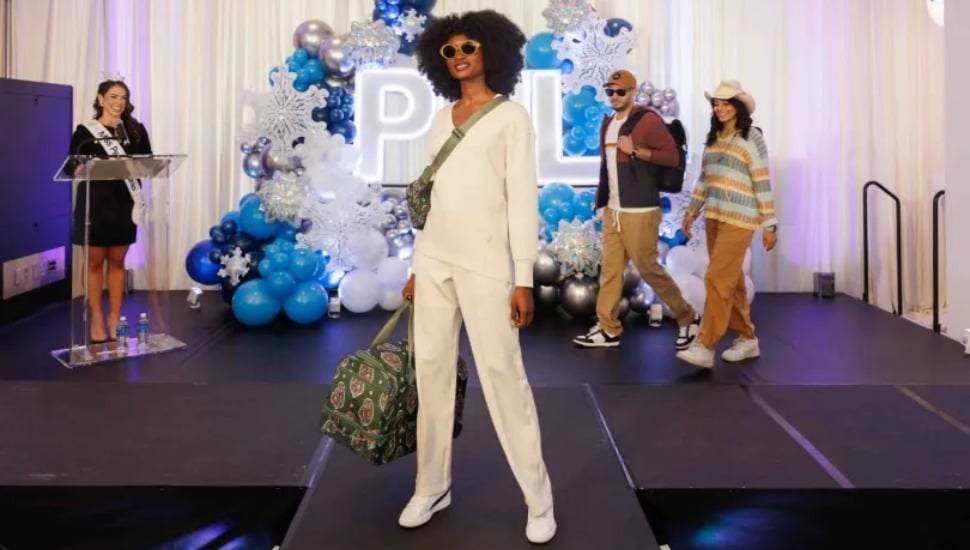 As Miss Pennsylvania Page Weinstein describes their outfits and accessories, airport workers take to the fashion runway.