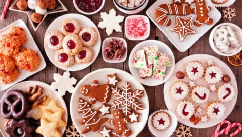 Christmas table scene of assorted sweets and holiday cookies.