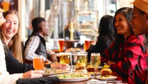 People enjoying food and drinks at Iron Hill Brewery.