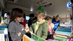 Kids picking out books from the Lending Library with Love.