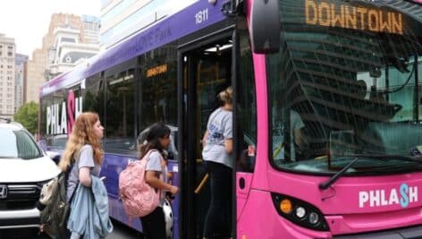 People walking on board the Philly PHLASH bus.