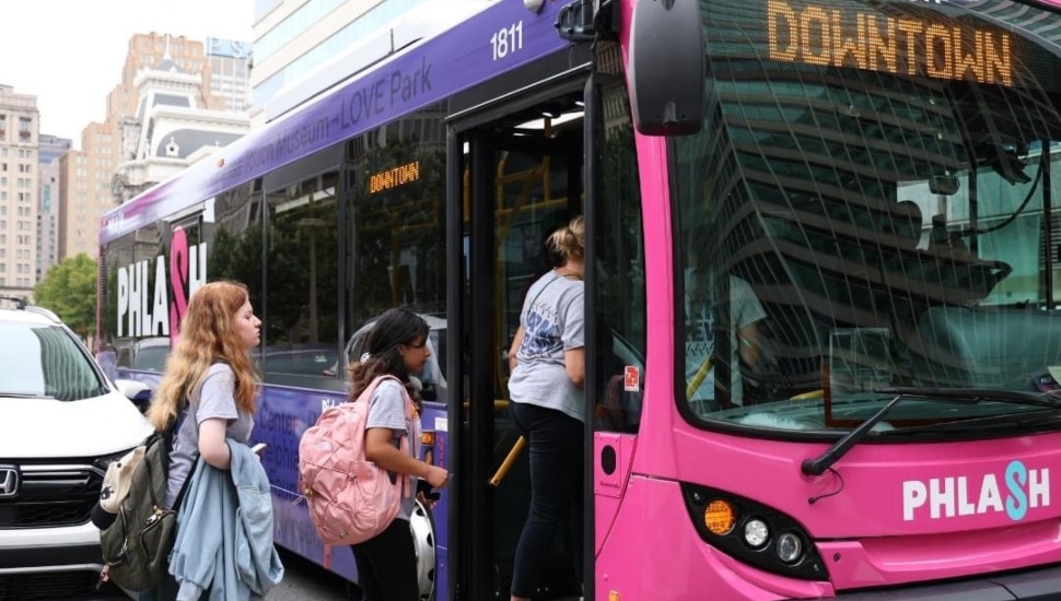 People walking on board the Philly PHLASH bus.