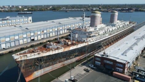 Wide shot photo of the SS United States in the water.