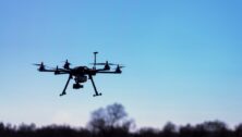 A drone flying over a rural sky.