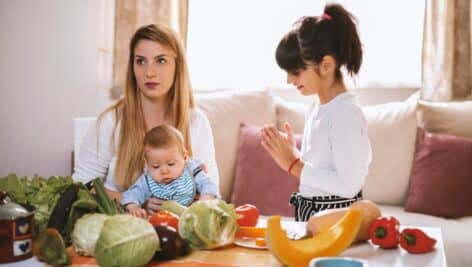 Mother and two young children with food.