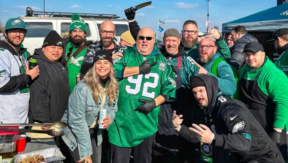 Eagles fans tailgating with Eagles gear on.
