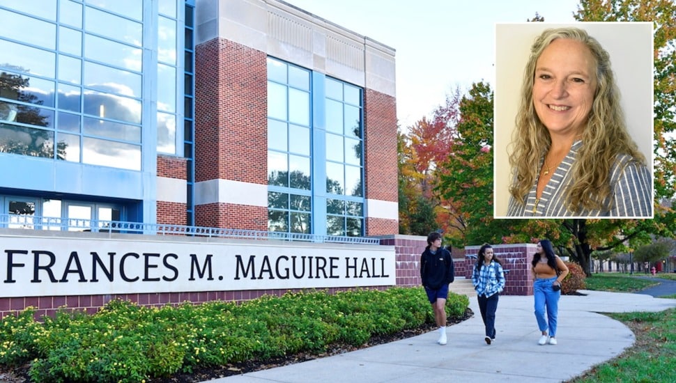 Nursing professor and students walking on a college campus.