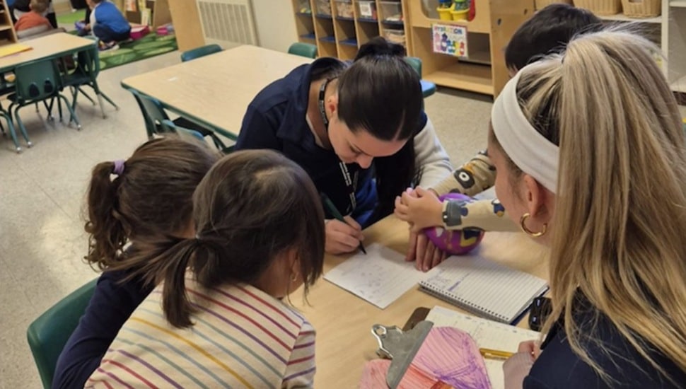 College student works with children at school.