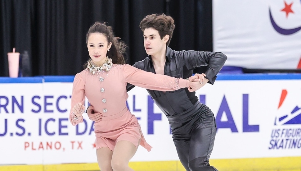 Blake Gilman and Julia Epps skate together on the rink.