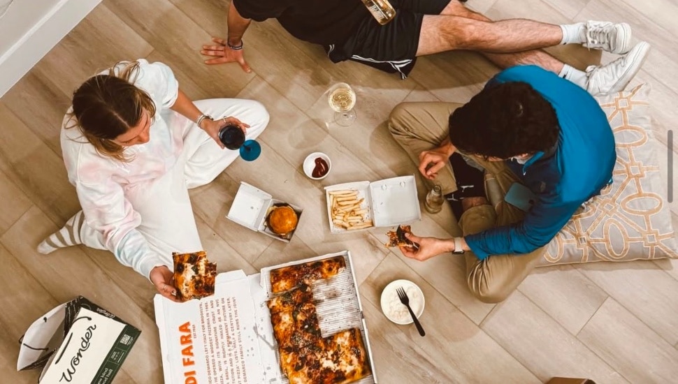 A group of three people enjoying food delivered through Wonder.