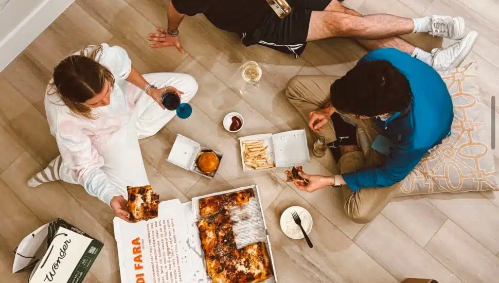 A group of three people enjoying food delivered through Wonder.