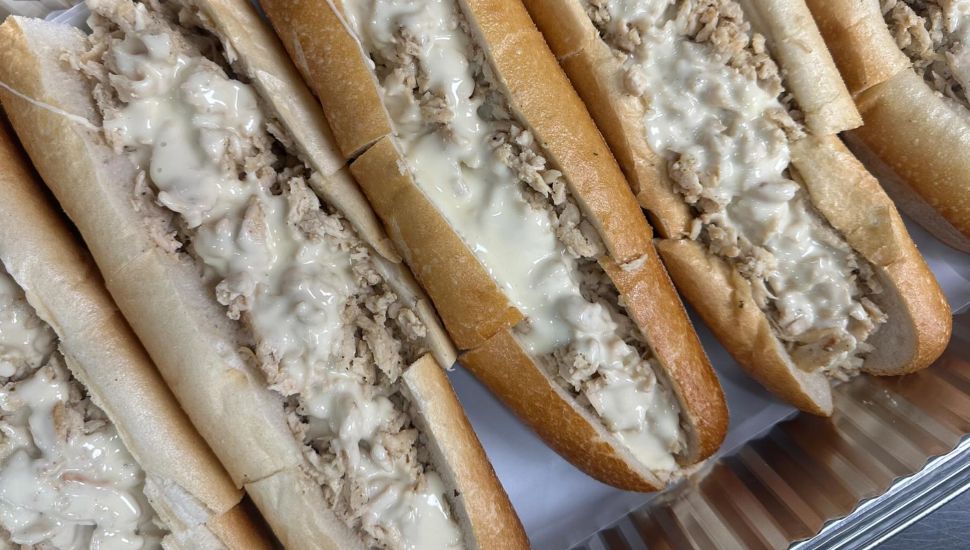 Chicken cheesesteaks in a row.